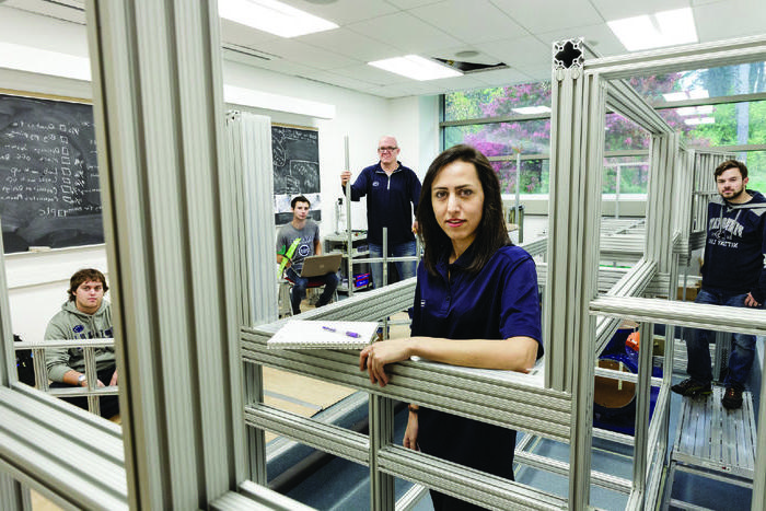 people in a room with metal framing