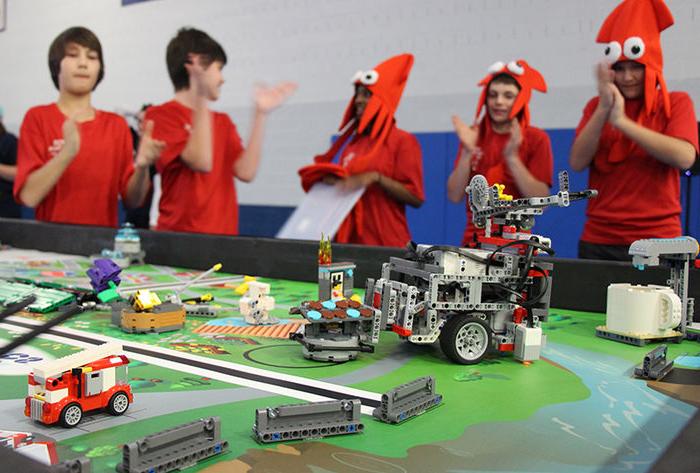 A team cheers on their robot during the competition rounds of the FIRST Lego League event
