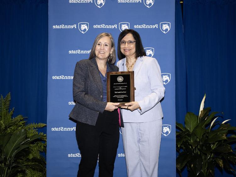 Lolita Paff poses with plaque and Neeli Bendapudi